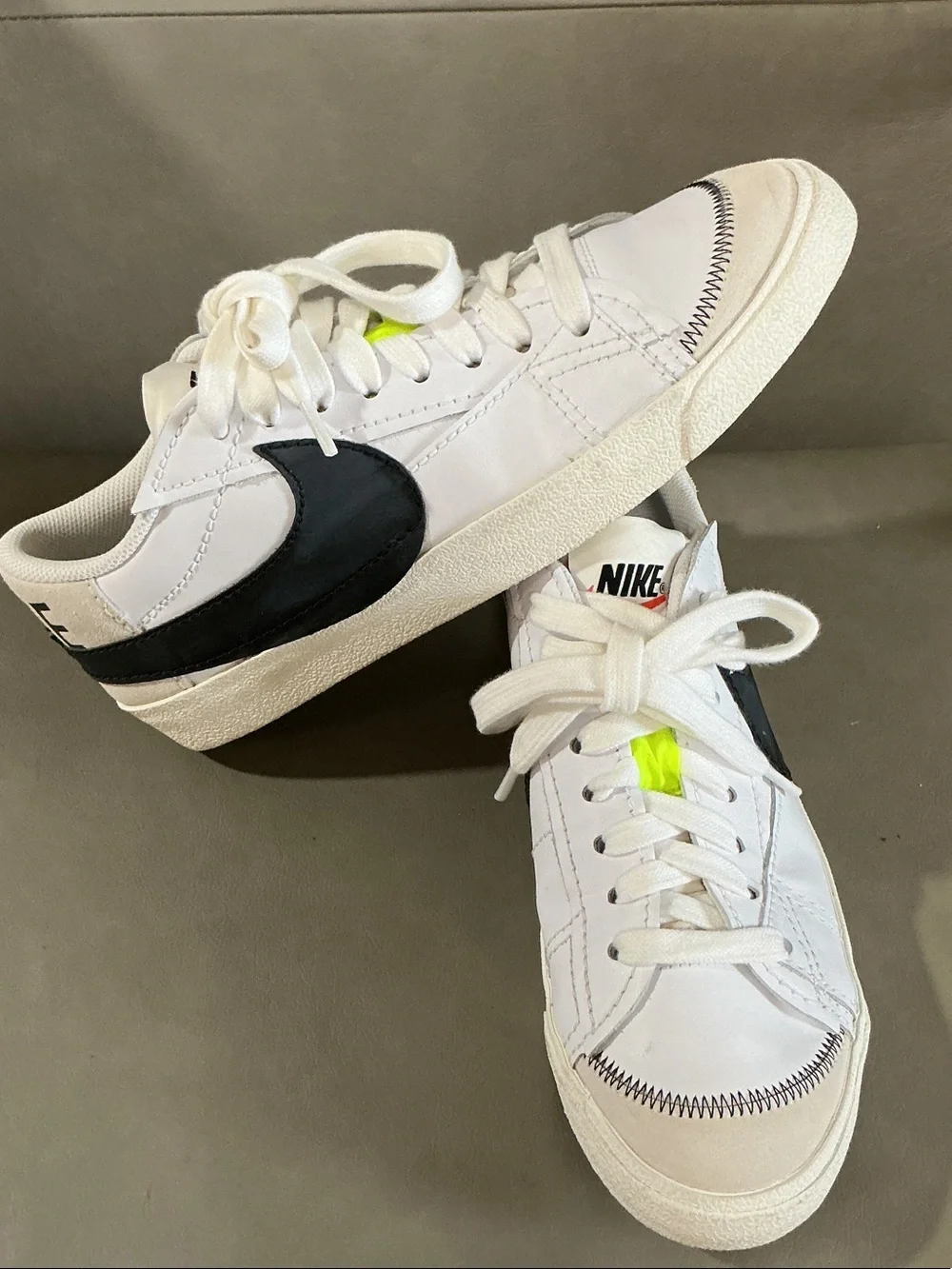Nike White Low-Top Sneakers with Black Swoosh and Neon Yellow Accents